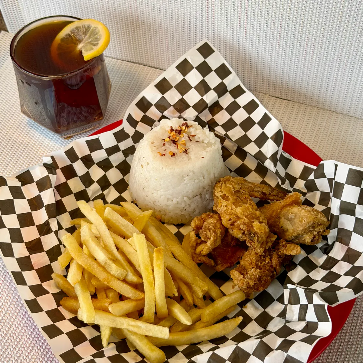 NamNam Powermeal - fried chicken, seasoned rice, and crispy fries in a checkered basket with iced tea